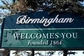 Teal 'Birmingham Welcomes You, Founded 1864' entrance sign in Birmingham, Michigan