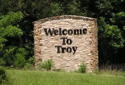 Stone 'Welcome to Troy' monument sign at a city entrance in Troy, Michigan